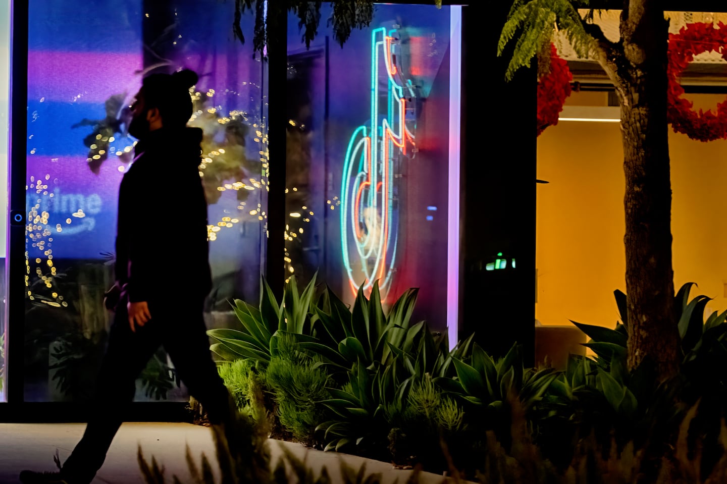 A neon TikTok logo hangs in the lobby of the TikTok office building in Culver City, California.