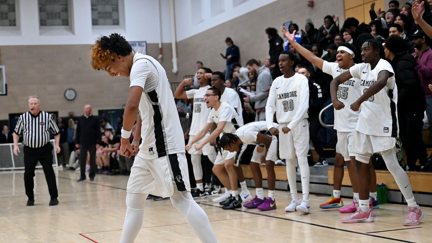 Dante Howard (left) and the Cambridge bench react to his basket late in the fourth quarter in a 68-66 win over No. 8 BC High.