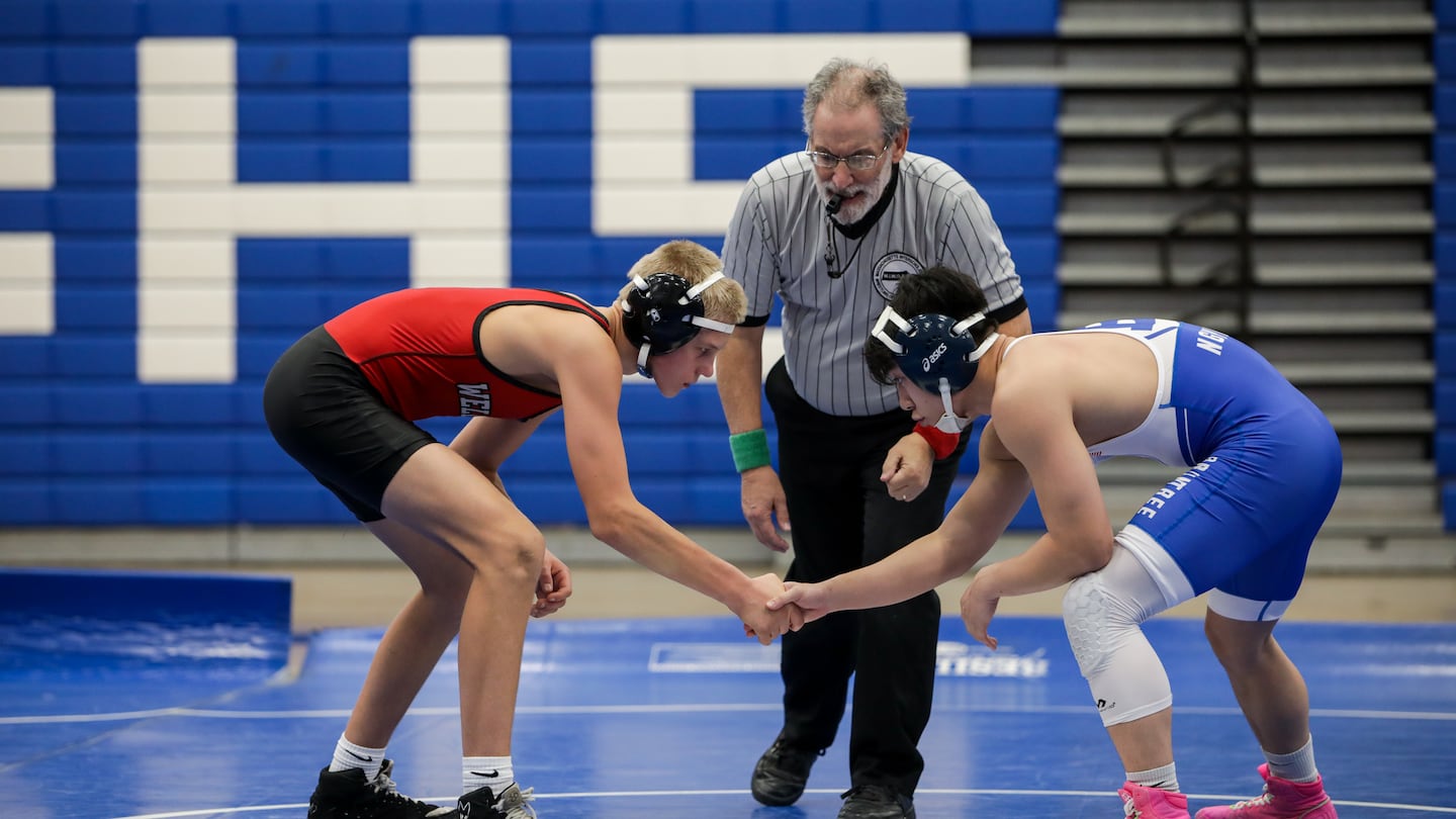 Wellesley sophomore Dominic Staunton (left) has racked up more than 50 wins already in his varsity wrestling career despite continuing issues from being hit by a car when he was 7.