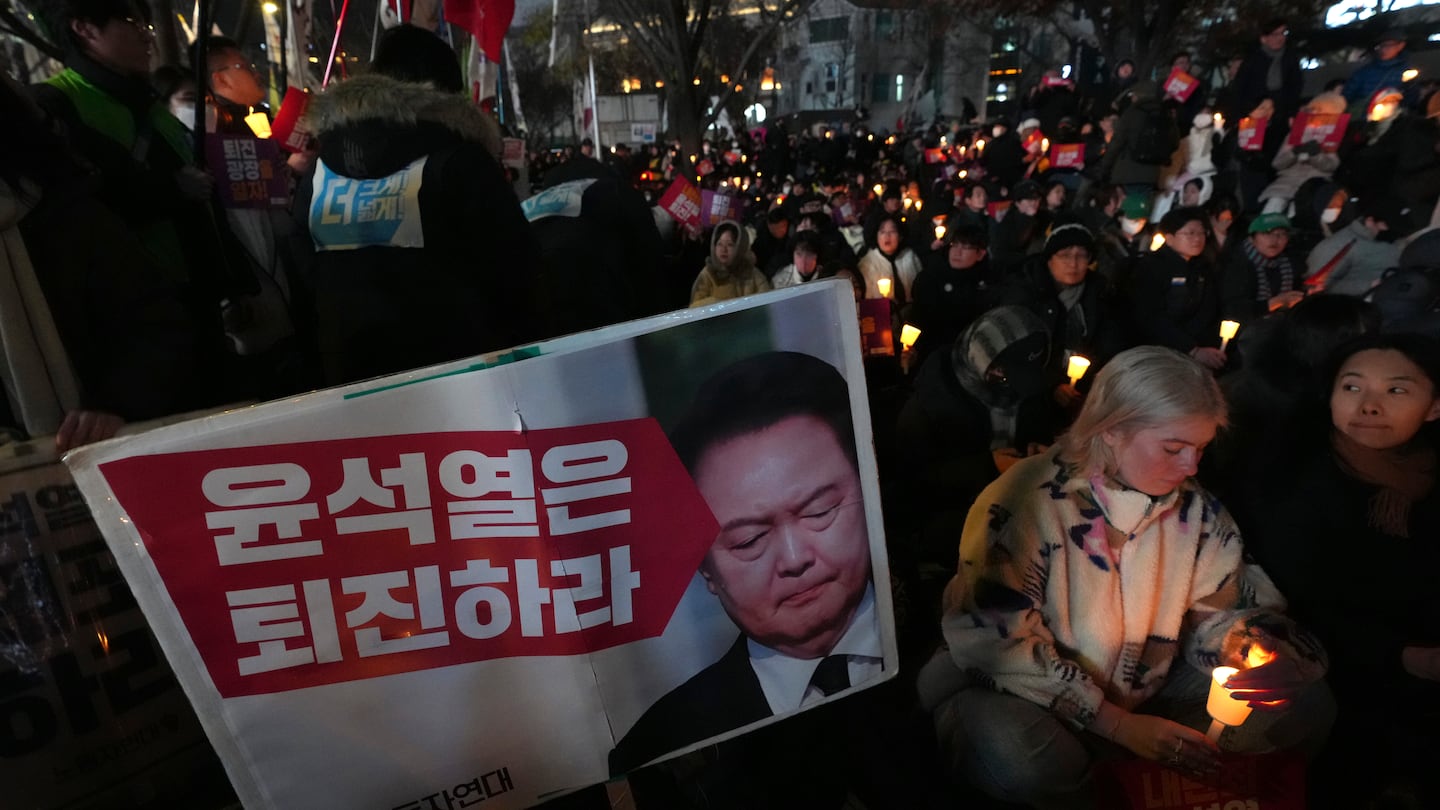 People hold candles during a candlelight vigil against South Korean President Yoon Suk Yeol in Seoul, South Korea, on Dec. 4.