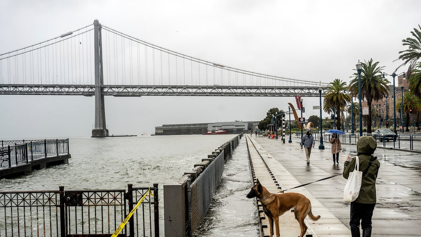 Water from the San Francisco Bay spills onto the Embarcadero in San Francisco on Dec. 14, as a result of high tides and storm-driven waves.