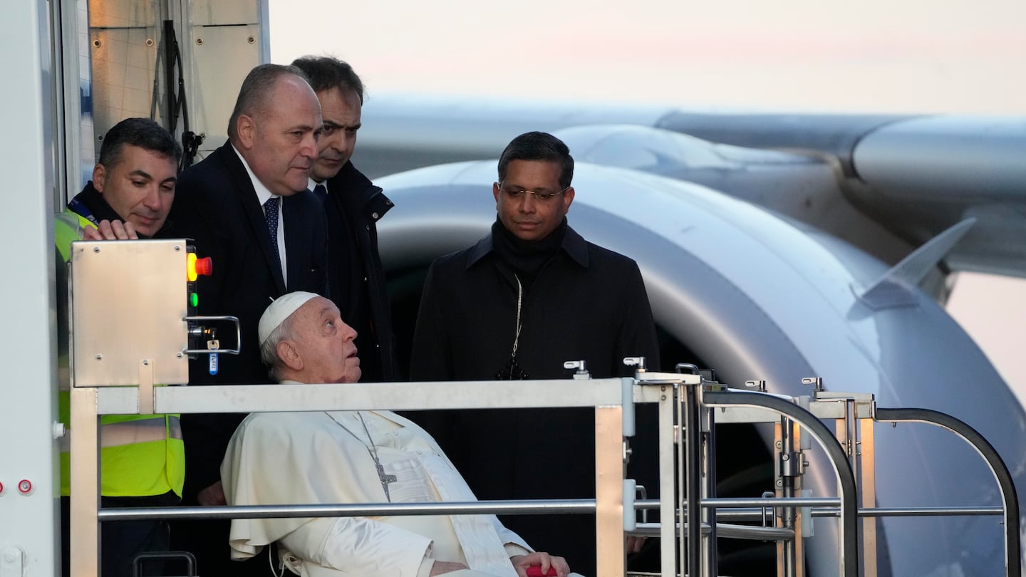 Pope Francis boards an airplane at Rome's Fiumicino airport as he leaves for his one-day visit to Ajaccio on the French island of Corsica, on Dec.15.