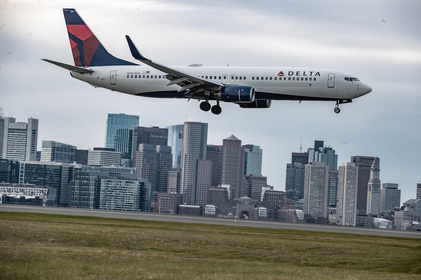 A jetliner at Logan Airport in Boston. Two men suspected of flying a drone close to Logan were arrested Saturday night.