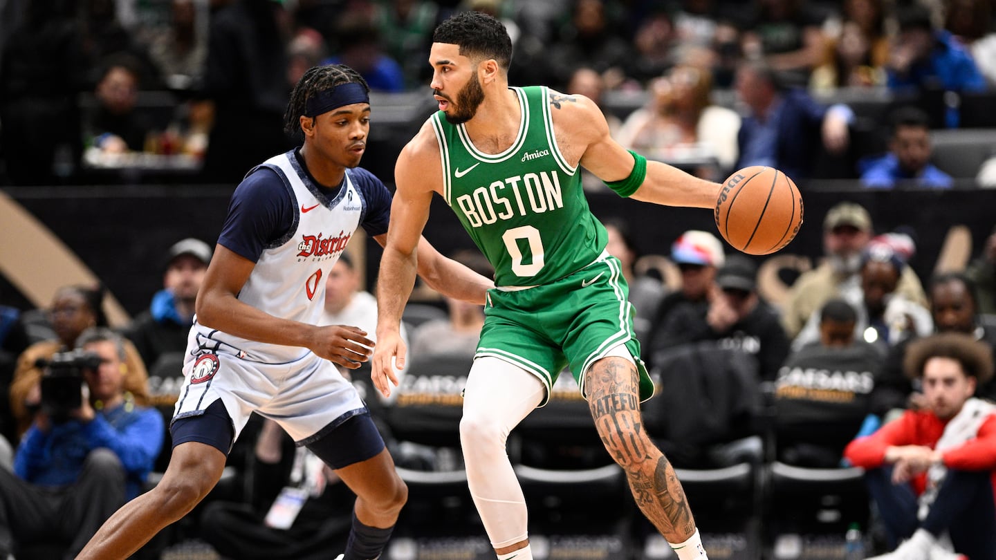 After missing Thursday night because of knee soreness, Jayson Tatum (right) scored a game-high 28 points and 12 rebounds as the Celtics won in Washington for a third time this season.