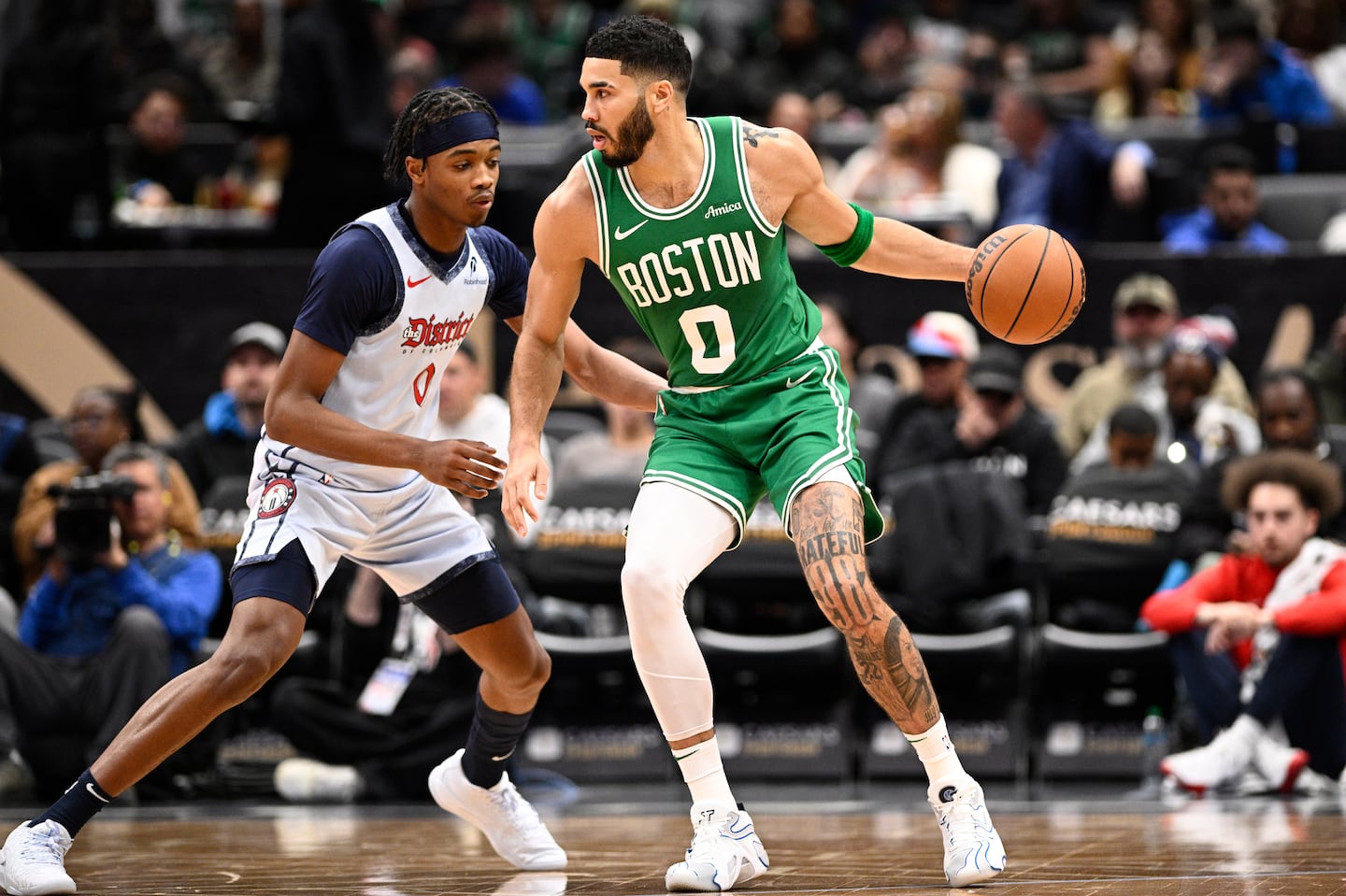 After missing Thursday night because of knee soreness, Jayson Tatum (right) scored a game-high 28 points and 12 rebounds as the Celtics won in Washington for a third time this season.