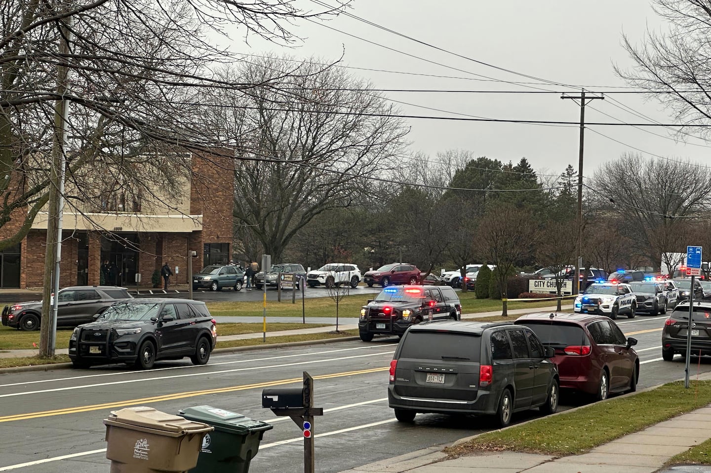 Emergency vehicles were parked outside the Abundant Life Christian School in Madison, Wis., where a shooting took place on Monday. 