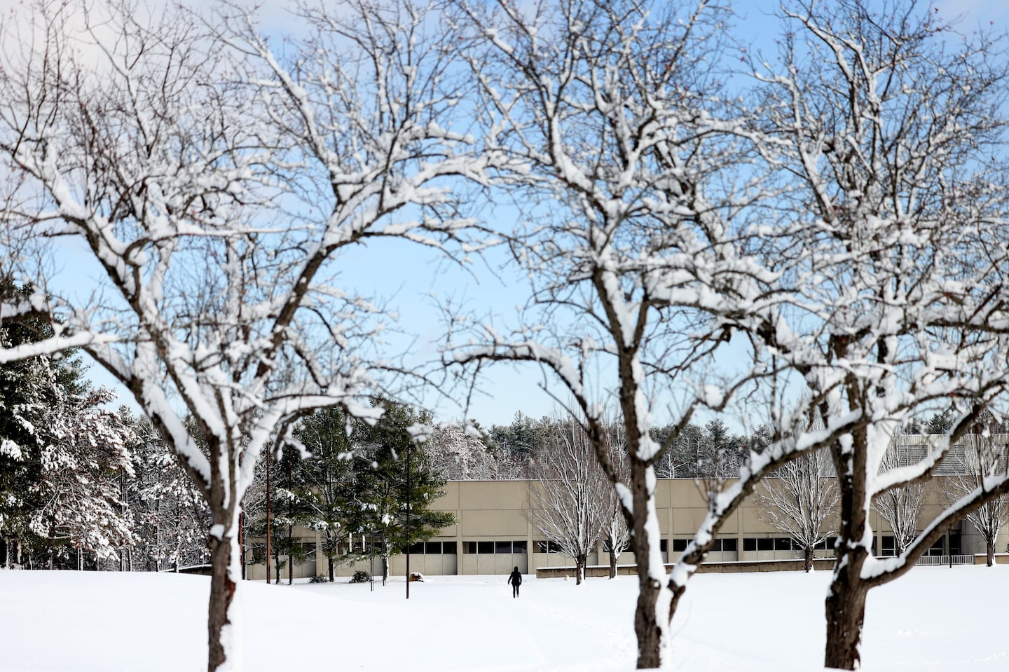 A person walks through the snow at Mount Wachusett Community College in Gardner, Mass., earlier this month.