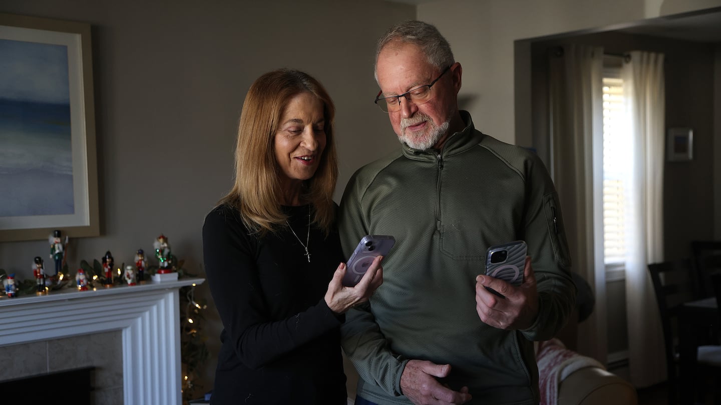 Steven Kahn and Diane Vanasse Kahn in their Peabody home with their phones. The couple got what they considered to be a great offer for new iPhones from T-Mobile at Costco in Everett. But when their statements arrived, the promised credits were nowhere to be found.