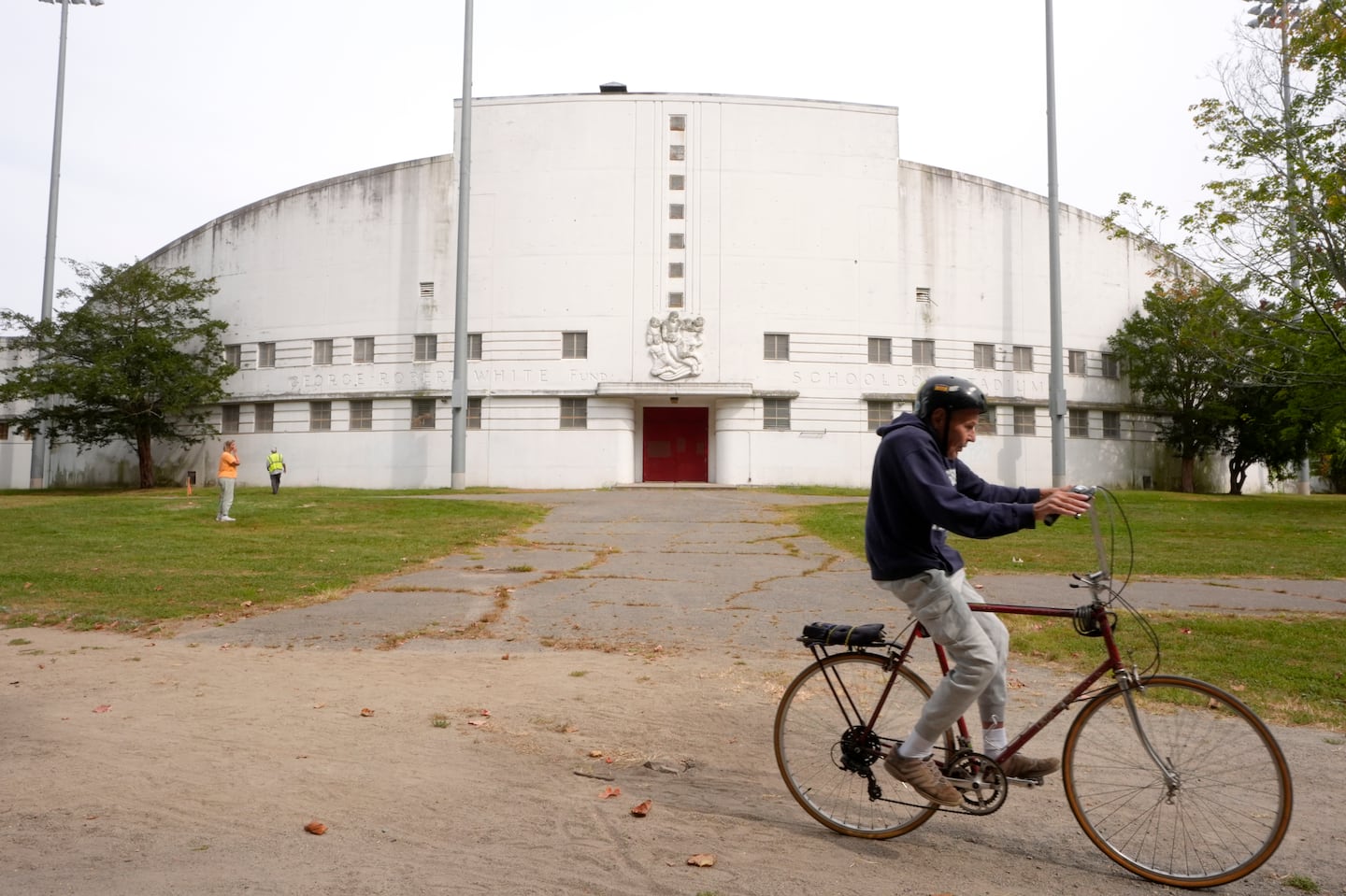 A person rode a bicycle past White Stadium in September in Boston.