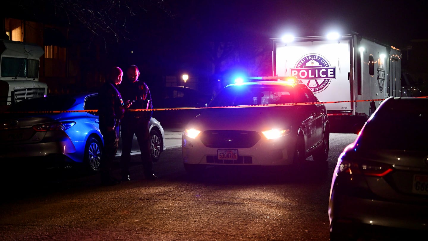 Police investigate a crime scene where they say multiple family members were found dead inside a home in West Valley City, Utah, on Dec. 17.