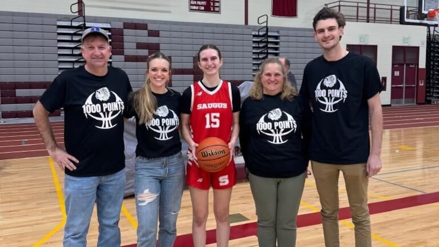 Saugus's Peyton Dibiasio poses with her coaches after scoring her 1,000th career point in a win over Gloucester.