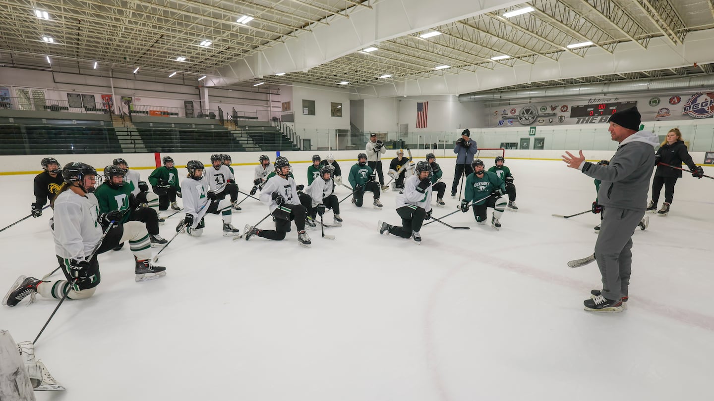 Duxbury High girls hockey head coach Dan Njarian talks to his top-ranked team during a preseason practice.