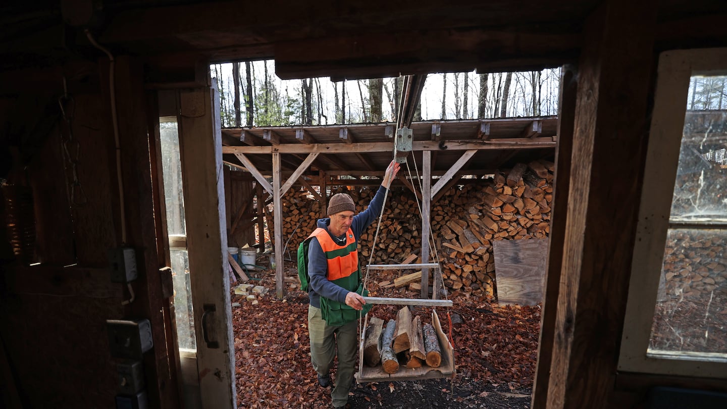 Tim Meeh moved firewood from the shed to the entrance of the sugarhouse at his North Family Farm in Canterbury, N.H.