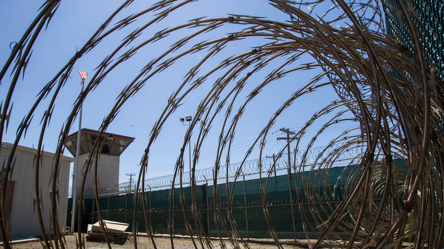 The control tower is seen through the razor wire inside the Camp VI detention facility in Guantanamo Bay Naval Base, Cuba.