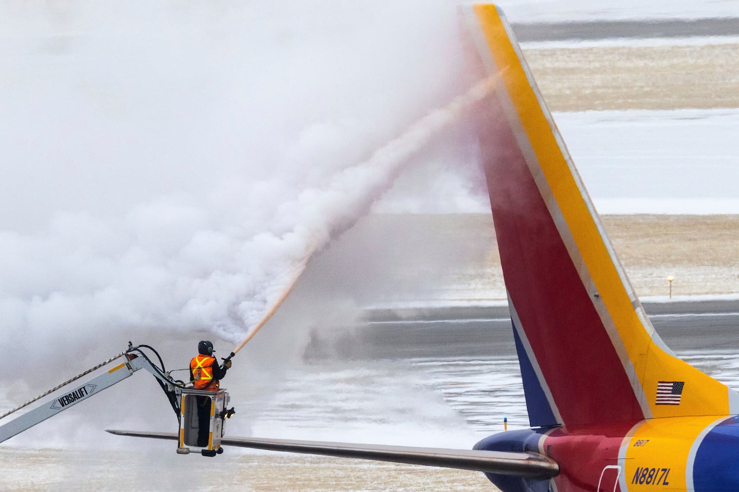 Crews deice a Southwest Airlines plane before takeoff on Dec. 21, 2022 in Omaha, Neb. Depending on where you're traveling this year, storms could disrupt your plans in the days leading up to Christmas and Hanukkah.