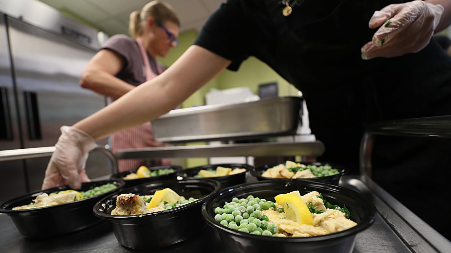 At Great Bay Community College in Portsmouth, N.H., volunteers makes meals destined for the Gather Pantry Market.