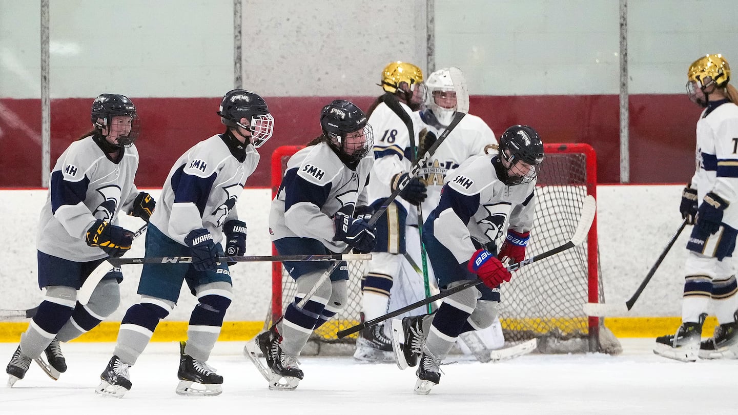 St. Mary's sixth-grader Emma Doucette (wearing red gloves) celebrates after scoring with 55 seconds left in the second period.