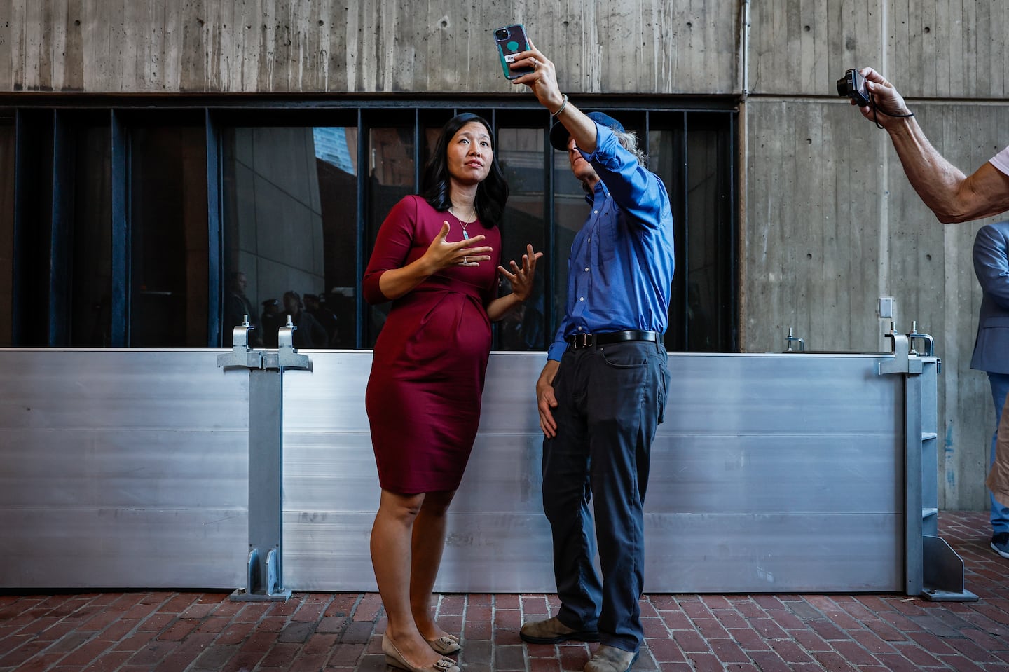 Boston Mayor Michelle Wu records a video with the Environmental Protection Agency’s David Cash demonstrating a flood barrier during the city's first annual Deployables Day, a training exercise focused on temporary flood protection measures.