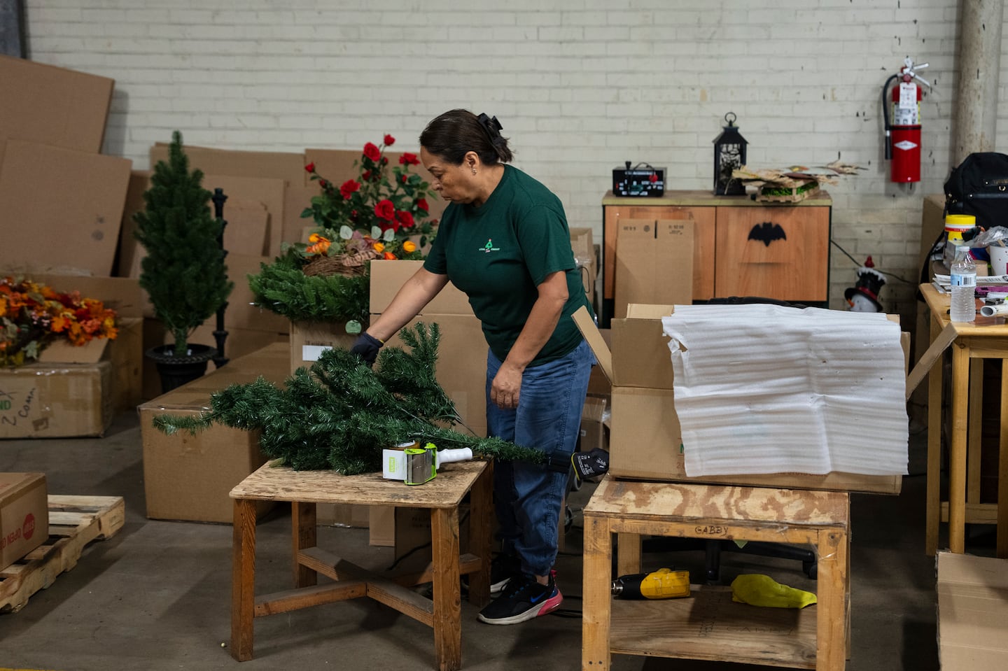 A worker prepared to box an artificial Christmas tree at a National Tree Co. warehouse, in Cranford, N.J., in Sept.