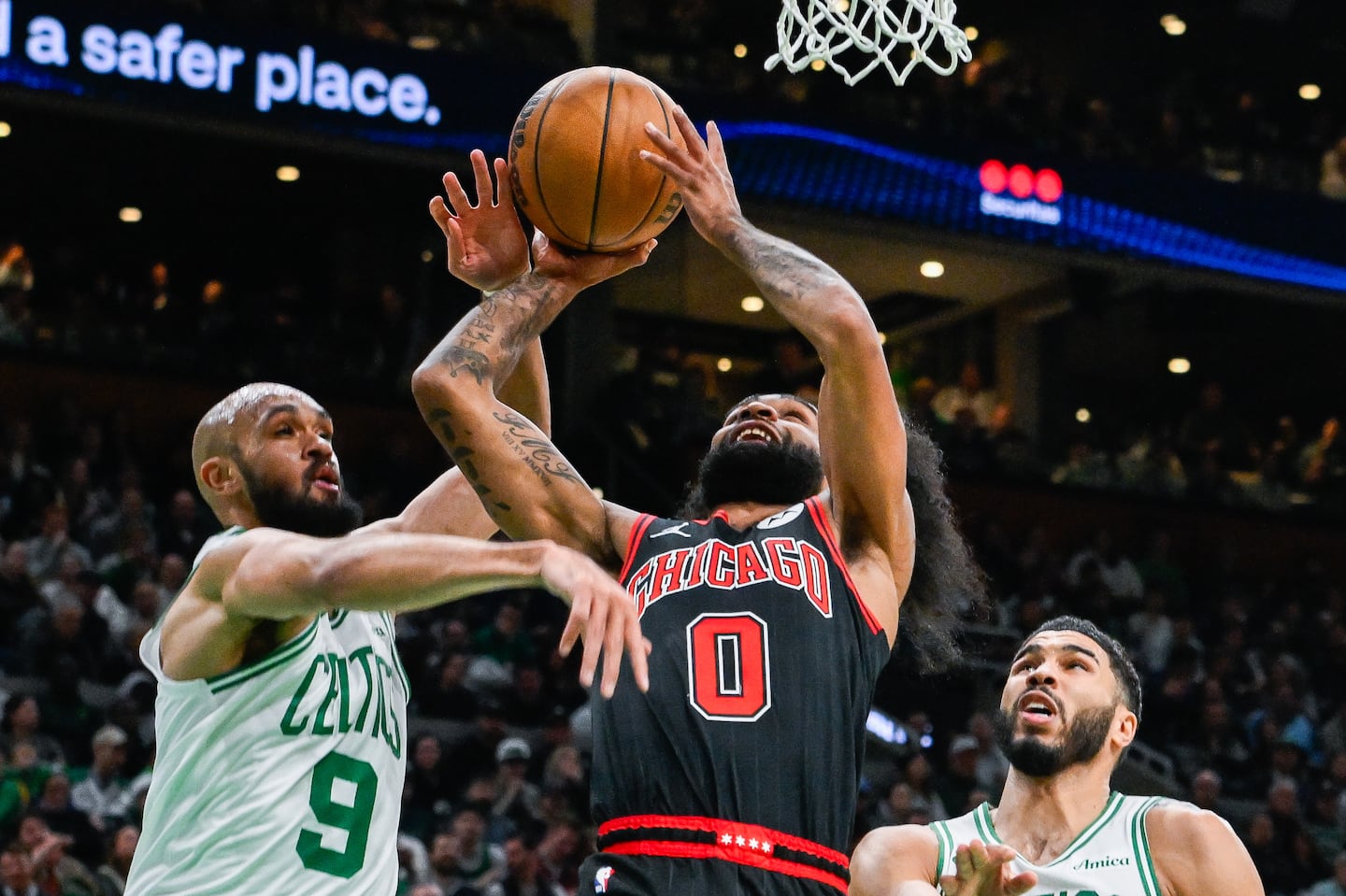 The Celtics' Derrick White tries to stop Bulls guard Coby White from getting to the basket in the second quarter Thursday night at TD Garden. 