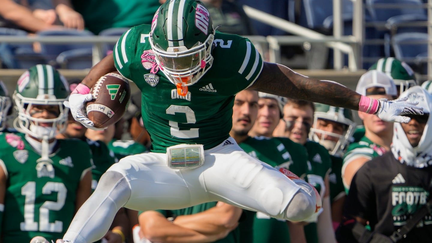 Ohio running back Anthony Tyus III leaps over Jacksonville State safety Antonio Carter for extra yardage on a run during the second quarter of the Cure Bowl.