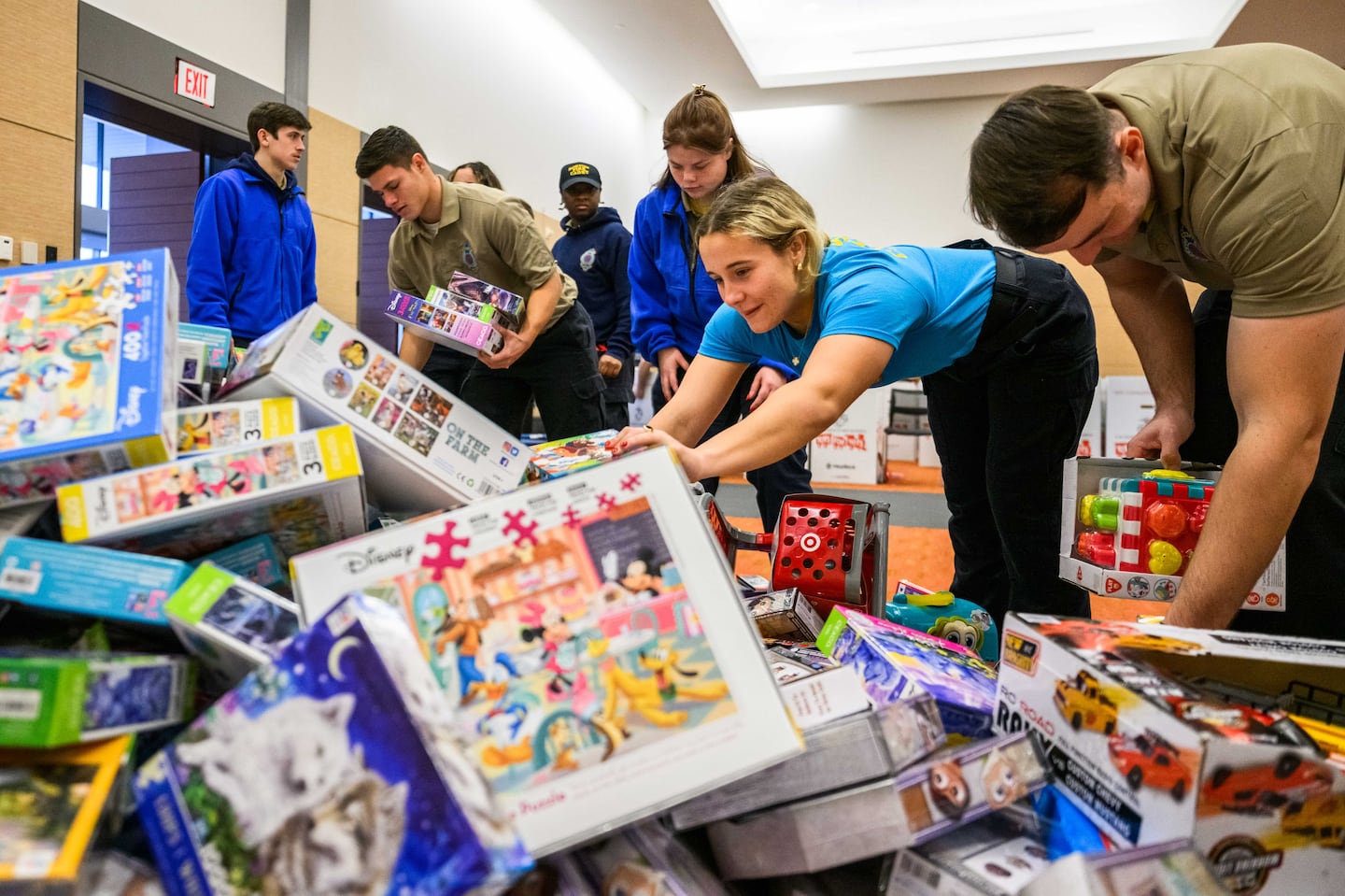 Fire cadets sorted through a mountain of toys at a Toys for Tots drive in the Boston Convention Center in South Boston on Friday.