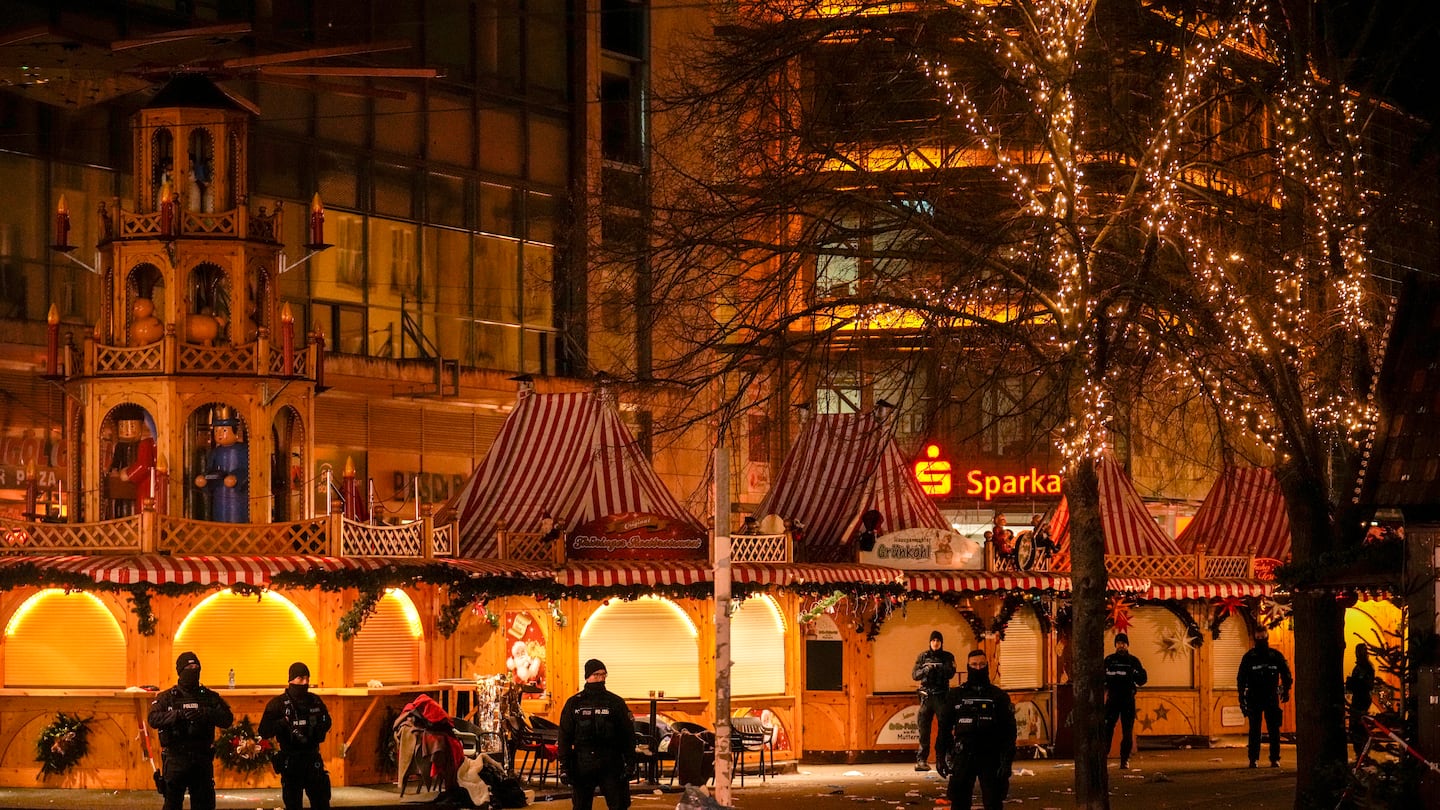 Security guards stand in front of a cordoned-off Christmas market after a car crashed into a crowd of people, in Magdeburg, Germany, on Dec. 21.