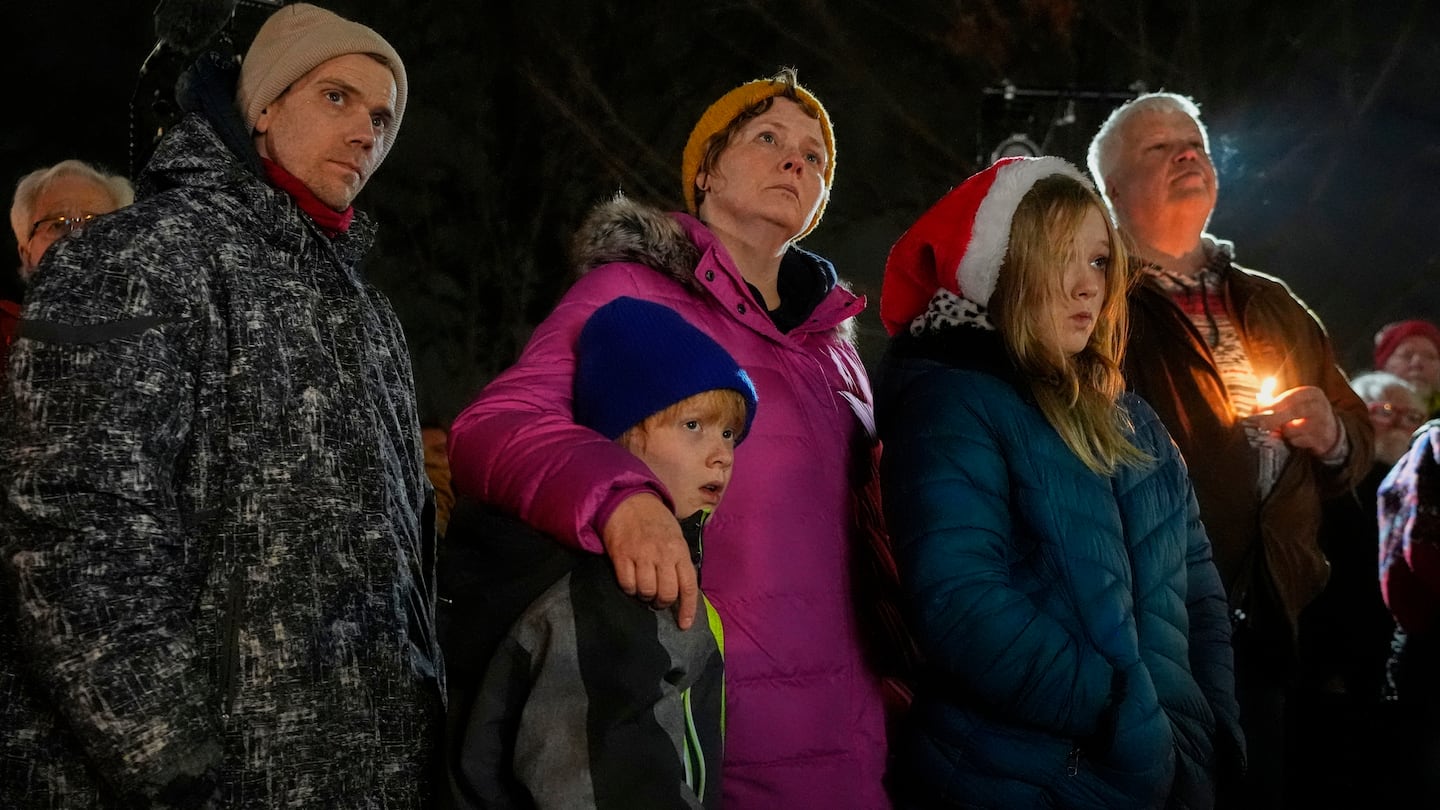 Supporters hold candles during a candlelight vigil, on Dec. 17, outside the Wisconsin Capitol in Madison, Wis., following a shooting at the Abundant Life Christian School the day before.