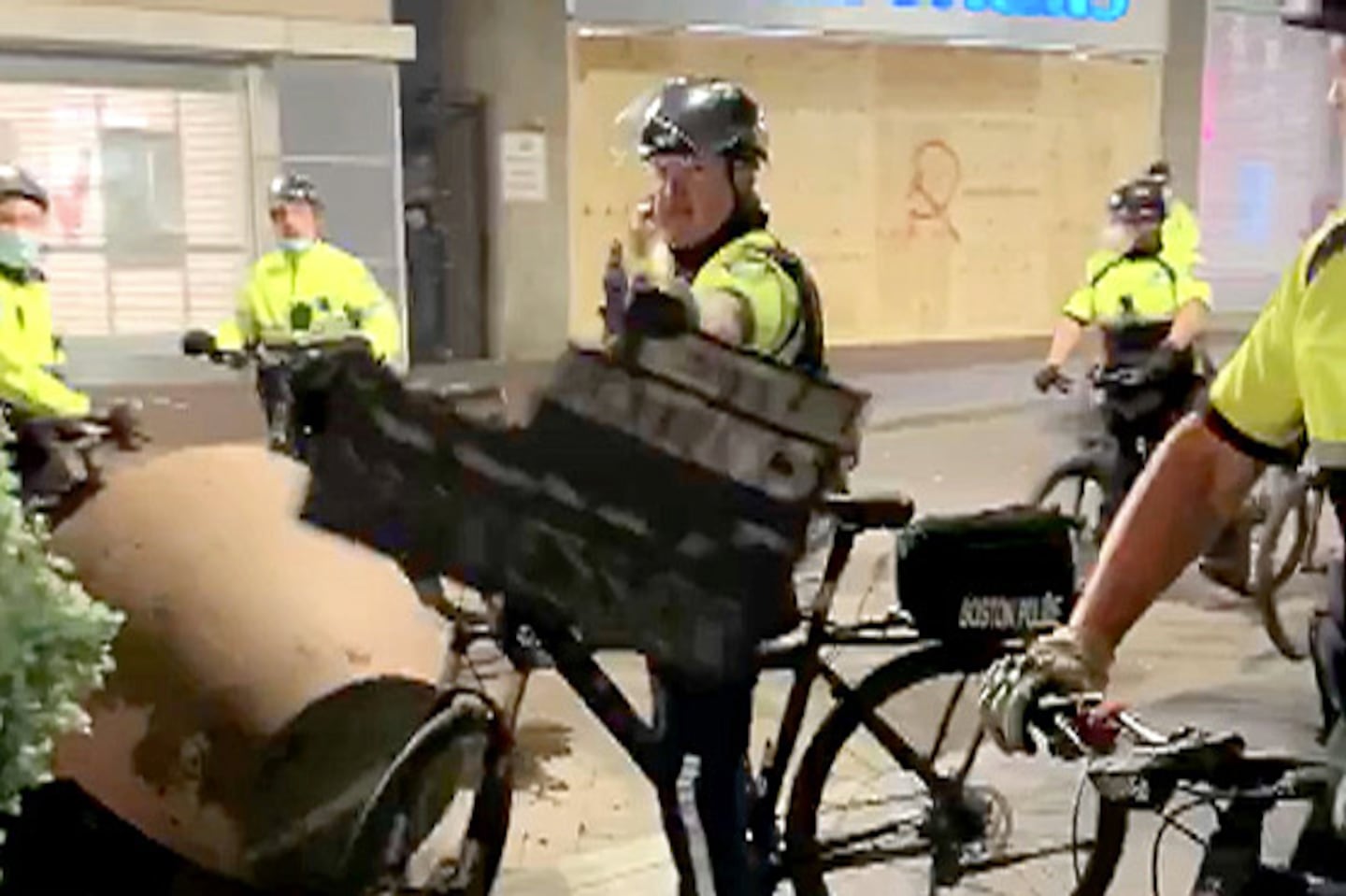 A still from a video showing John Danilecki rolling his bike alongside a Black male protester, who was carrying a sign — and possibly arguing — before Danilecki grabbed it out of the protester’s arm and tore it up.