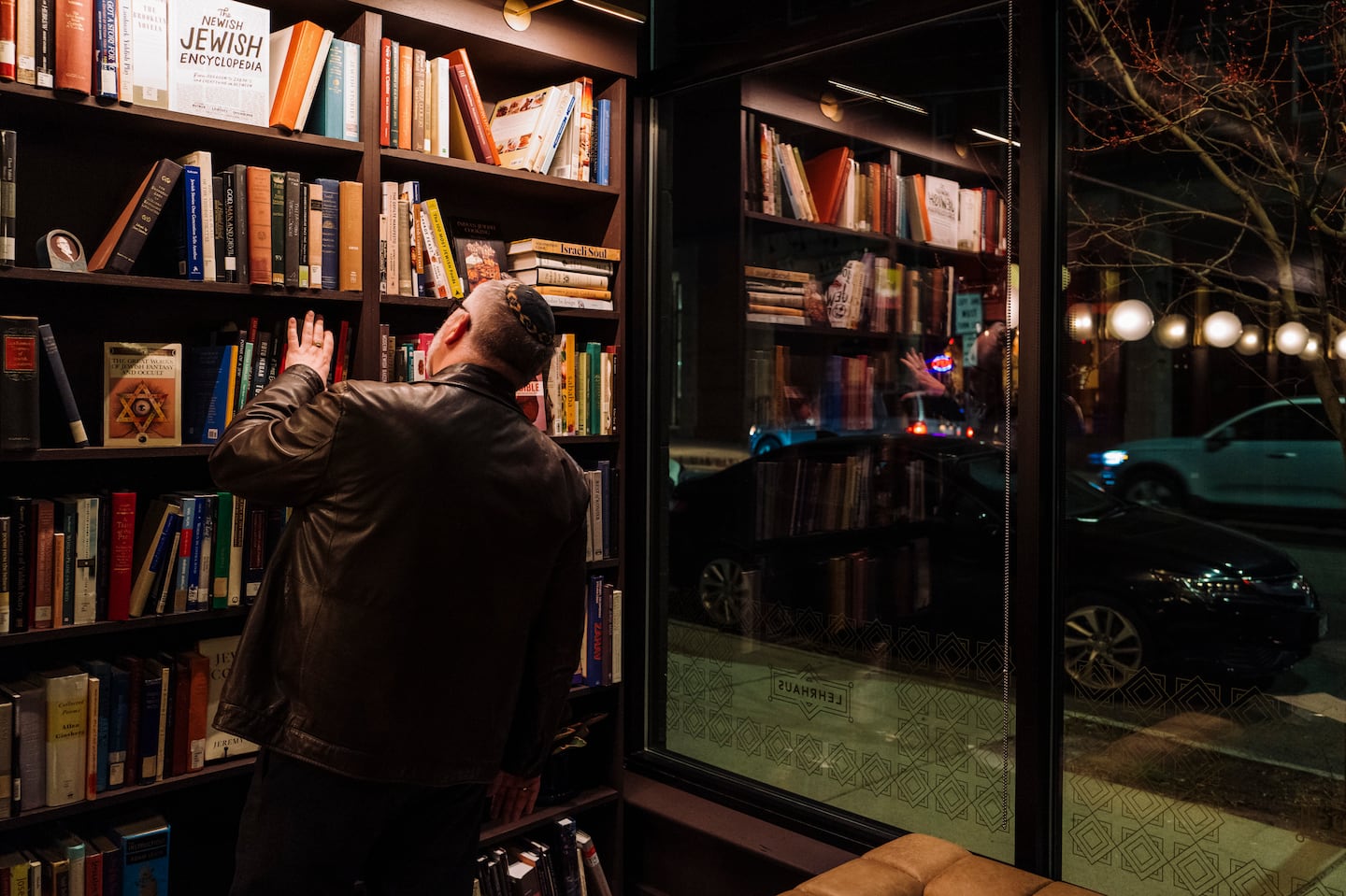 A man looked over books about various aspects of Jewish culture at Lehrhaus in Somerville on April 3, 2023.