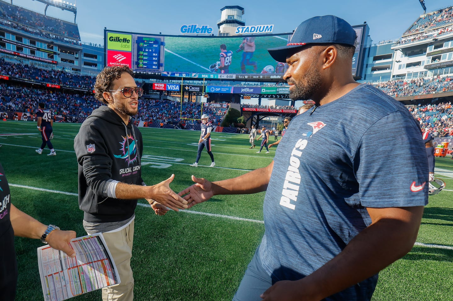 The Dolphins' Mike McDaniel (left) and the Patriots' Jerod Mayo enter the final stretch of the regular season looking to shake off scrutiny about their job security.