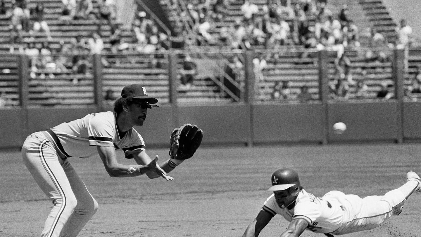 Oakland A's left fielder Rickey Henderson dove for third base in the first inning against Detroit Tigers Enos Cabell during a game in 1982.