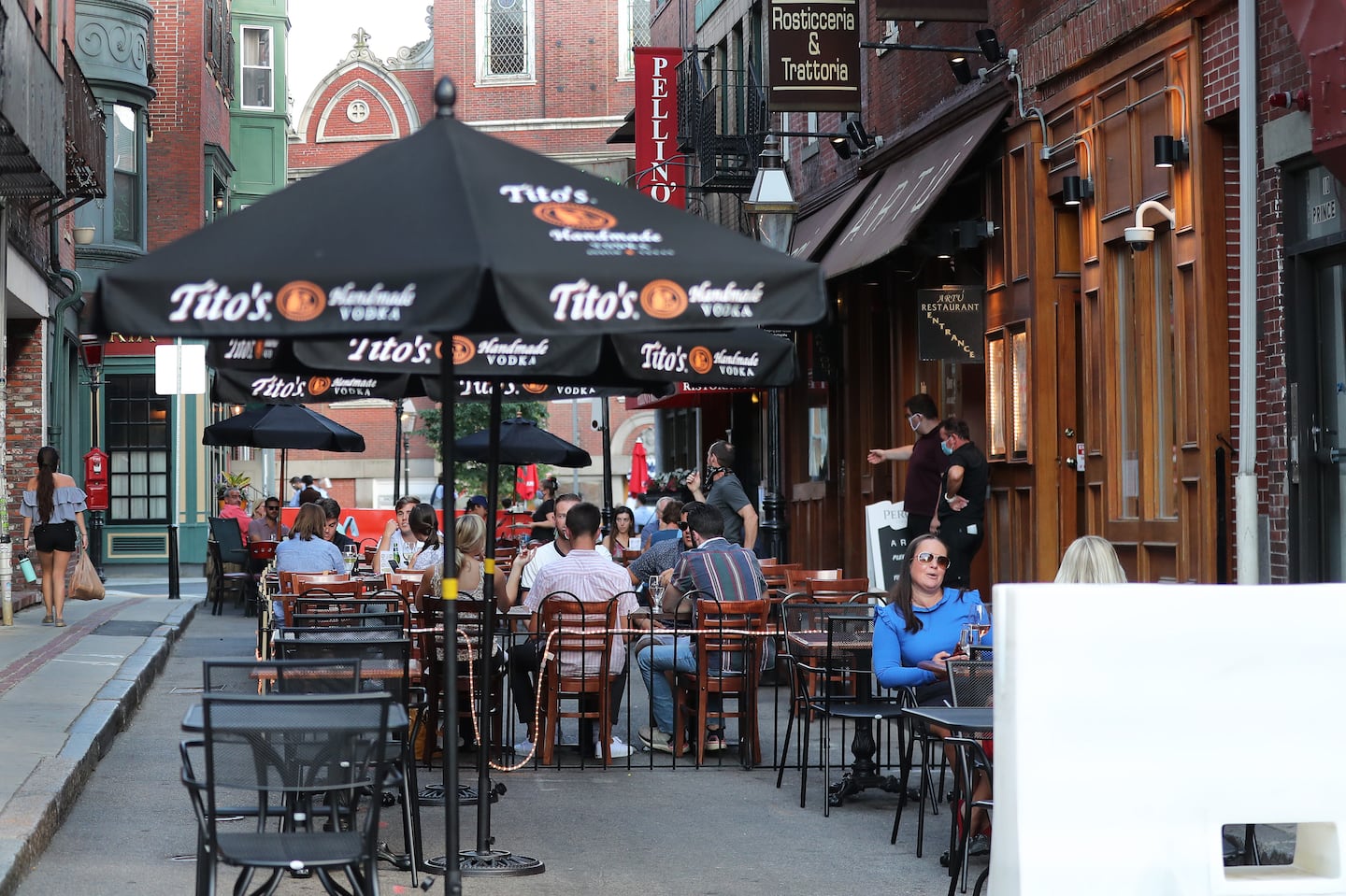 In 2020 in Boston's North End, outdoor dining included these tables on Prince Street at the corner of Hanover Street.