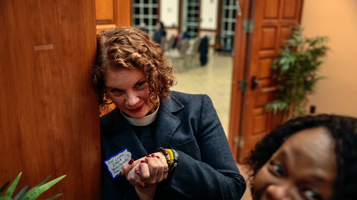 Rev. Laura Everett (left), executive director of the Massachusetts Council of Churches, greeted Geralde Gabeau, director of the Immigrant Family Services Institute, at a meeting of Greater Boston congregations in Newton on Dec. 17.