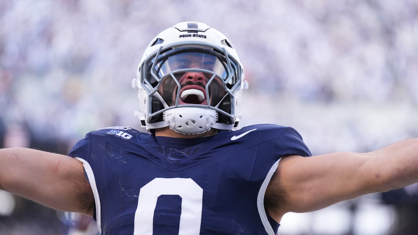 Penn State's Dominic DeLuca celebrates returning an interception after intercepting a pass and returning it 23 yards for a touchdown in the first quarter.