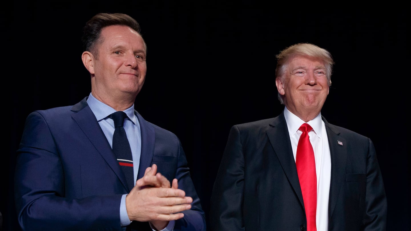 Television producer Mark Burnett (left) looks on as President Donald Trump arrives for the National Prayer Breakfast in 2017.